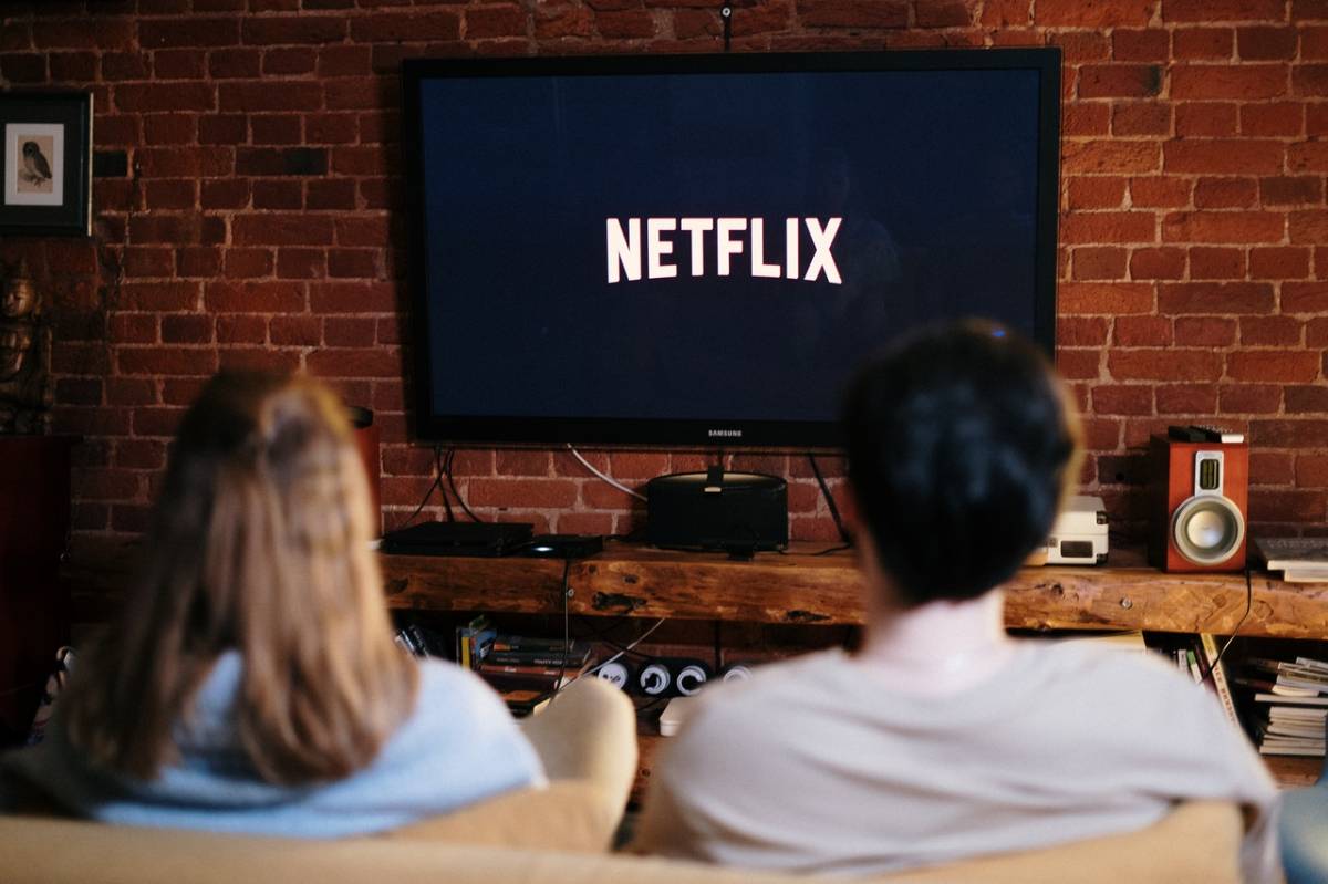 two individuals watching Netflix